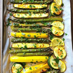 - 1 bunch of fresh asparagus, trimmed - 2 medium zucchinis, sliced into half-moons - 2 medium yellow squashes, sliced into half-moons - 3 cloves garlic, minced - 3 tablespoons olive oil - 1 teaspoon lemon zest - 2 tablespoons fresh lemon juice - Salt and pepper to taste - 1/4 teaspoon red pepper flakes (optional) - 1/4 cup grated Parmesan cheese (optional) - Fresh parsley or basil for garnish I love using fresh vegetables for this dish. Asparagus gives a nice crunch. Zucchini and yellow squash add sweetness. When you combine these three, you get a great mix of flavors. For the flavor enhancers, garlic is a must. It brings out the taste of the veggies. Olive oil helps everything roast nicely. Lemon zest and juice add brightness. A pinch of red pepper flakes gives a little kick. Cheese is optional but makes it special. Gather these ingredients, and you are ready to start cooking. You can find the full recipe linked to ensure every detail is covered. Enjoy the fresh tastes! - Preheat the oven to 425°F (220°C). - In a large bowl, combine the asparagus, zucchinis, and yellow squashes. - Drizzle the veggies with olive oil. - Add minced garlic, lemon zest, lemon juice, salt, pepper, and red pepper flakes. - Toss everything until the vegetables are evenly coated. - Spread the mixture on a baking sheet lined with parchment paper. - Roast in the oven for 15 to 20 minutes. - Toss the veggies halfway through to ensure even cooking. - If you like, add grated Parmesan cheese during the last 5 minutes. - Remove from the oven and garnish with fresh herbs before serving. This easy recipe makes flavorful asparagus with zucchini and squash. Check out the Full Recipe for more details! How do you know when asparagus is done? Look for bright green color and slight bend. The tips should be soft, but not mushy. If you poke it with a fork, it should feel tender. To get your vegetables caramelized, keep them in a single layer on the baking sheet. This way, the heat can reach all sides. Toss them halfway through cooking to ensure even browning. A little olive oil helps too; it promotes that nice golden color. What herbs and spices can you add? Fresh thyme, rosemary, or oregano pair well with this dish. A sprinkle of garlic powder can boost the flavor too. If you want heat, try adding a pinch of cayenne pepper. How do you adjust salt and acidity? Start with a little salt and taste as you go. You can always add more later. For acidity, fresh lemon juice brightens the dish. If it's too sour, balance it with a touch of honey. {{image_2}} You can change up the main veggies in this dish. If you want, substitute asparagus with broccoli or green beans. Both options bring a nice crunch and flavor. You can also add bell peppers, carrots, or even cherry tomatoes for a colorful mix. Each swap makes the dish unique and tasty. If you need gluten-free options, use gluten-free seasonings like tamari instead of soy sauce. When it comes to cheese, you can skip it entirely for a lighter version. For vegan choices, try nutritional yeast for a cheesy flavor without dairy. This way, everyone can enjoy a delicious meal! For the full recipe, check out the details above. To store leftovers, wait for the dish to cool down. Place the asparagus, zucchini, and squash in an airtight container. This helps keep them fresh. You can store it in the fridge for up to three days. After that, the flavors may fade, and the veggies could get soggy. When you're ready to eat, reheat the dish carefully. The best way is to use an oven. Preheat the oven to 350°F (175°C). Place the vegetables on a baking sheet. Heat for about 10 minutes. This method keeps the flavors intact and the veggies crispy. You can also use a microwave, but be careful. Heat in short bursts to avoid mushy vegetables. Enjoy your flavorful asparagus delight with zucchini and squash! For the full recipe, check out the earlier section. To make this dish more nutritious, you can add protein and fiber. Here are some ideas: - Add cooked quinoa or brown rice for fiber. - Toss in chickpeas or lentils for plant-based protein. - Include nuts or seeds, like almonds or sunflower seeds, for crunch and protein. - You can also mix in spinach or kale for extra vitamins. These additions boost the dish's nutrition and keep it tasty. Yes, you can prepare this dish in advance. Here are some tips: - Chop the vegetables ahead of time and store them in the fridge. - Toss the veggies with olive oil and seasonings right before cooking. - If you roast them ahead, let them cool and store in an airtight container. - Reheat gently in the oven or microwave before serving. This way, you save time on busy nights. Pair this dish with a variety of sides or mains. Here are some ideas: - Serve it with grilled chicken or fish for protein. - Pair it with a light pasta for a heartier meal. - Add a fresh salad for extra crunch. - Try it with a grain like quinoa or couscous for a filling option. These combinations make for a balanced meal. Yes, this dish fits well into meal prep routines. Here are some ideas: - Roast a big batch on the weekend for quick meals. - Store portions in separate containers for easy access. - Mix it with your favorite protein for quick lunches. - Pair it with grains or salads for variety throughout the week. Meal prepping this dish saves time and keeps meals exciting. This post covered how to make tasty roasted asparagus, zucchini, and squash. We discussed fresh veggies, flavor enhancers, and roasting steps. I also shared tips, tricks, and storage info. You can customize this dish with swaps and dietary choices. In closing, remember, simple ingredients can shine with the right touches. Enjoy your cooking adventure!
